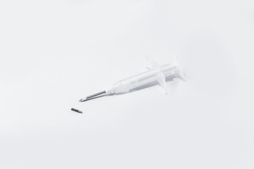 syringe with a microchip on a light background, no one, close up