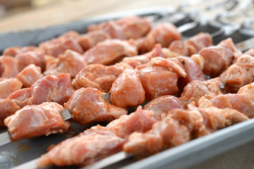 Raw meat on a metal skewer. Pork kebab. Soft focus