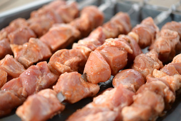 Raw meat on a metal skewer. Pork kebab. Soft focus