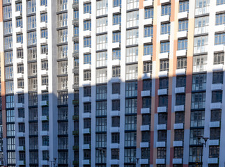 Pattern from the windows of a new multi-storey building. Window in modern architecture. Apartment house, new building.