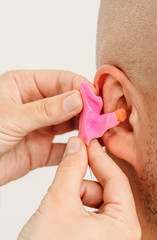 Process of making earplug from an impression of an individual’s human ear. Ear close-up. Personally molded earplugs. Solution for noisy places. Part of the set