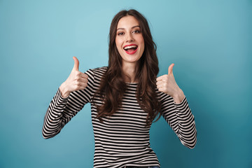 Image of happy caucasian woman smiling and showing thumbs up