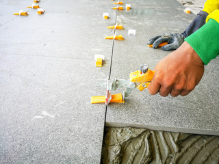Tile work placing ceramic floor tile in  with lash tile leveling system