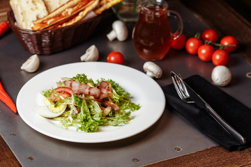 Light salad with vegetables bacon cherry grilled mushrooms tomatoes egg. delicious summer lunch