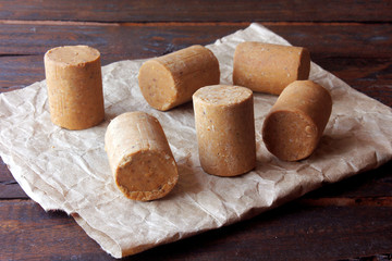 Peanut candy (paçoca or pacoca) traditional Brazilian sweet based on peanuts, manioc flour and sugar on a rustic wooden table