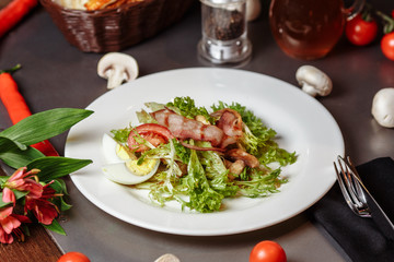 Light salad with vegetables bacon cherry grilled mushrooms tomatoes egg. delicious summer lunch