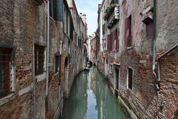 Fototapeta na wymiar Typical houses along a canal in Venice, Italy 