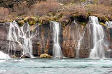 Naklejka premium Hraunfossar waterfall cascade in the Reykholt area in Iceland. Travelling, nature and holiday concept.