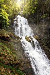 Idyllic waterfall in forest crashing over rocks. Famous Waterfalls Giessbach in the Bernese Oberland near Brienz, Switzerland.