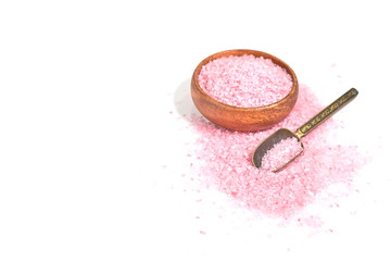 Pink salt isolated in scoop on white background. selective focus or blurry.