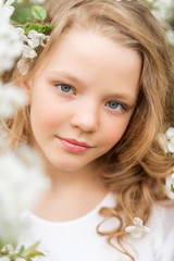 Close-up portrait of a beautiful girl with white flowers