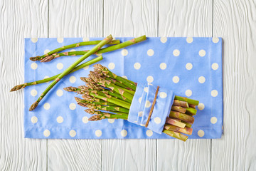a bunch of fresh asparagus on a blue napkin