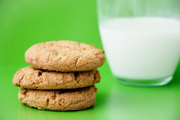 Fototapeta na wymiar milk and cookies on green background