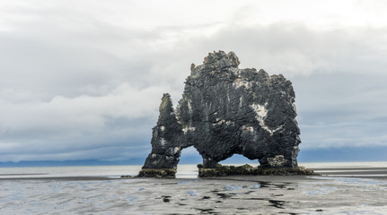 Hvitserkur basalt volcanic rock formation looking like a drinking dragon in Vatnsnes peninsula in northern Iceland. Holiday and landscape concept.