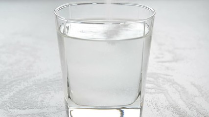 Preparing salt water by stirring salt and water. Salt water has high level of minerals and salt water gargle helps in removing of cold and sore throat