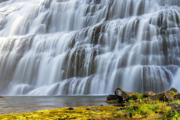The big and powerful Dynjandi waterfall in the westfjords of Iceland during summer and sunny day. Holiday and travelling concept.