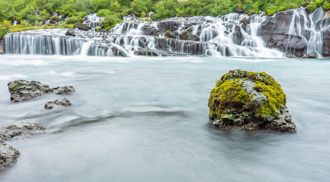Hraunfossar volcanic streams and cascade early morning in the Reykholt area in Iceland. Holiday and nature photography concept.