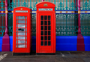 Two red iconic phone boxes in central London, United Kingdom.