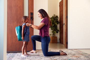 Mother Saying Goodbye To Daughter As She Leaves Home For School