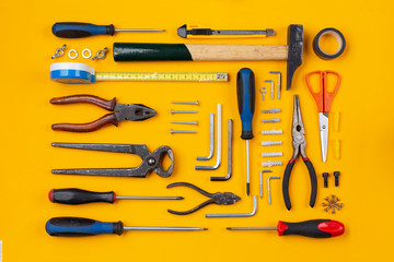Work tools arranged on an orange background