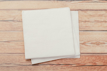 white paper napkin or tissue on the wooden table background.