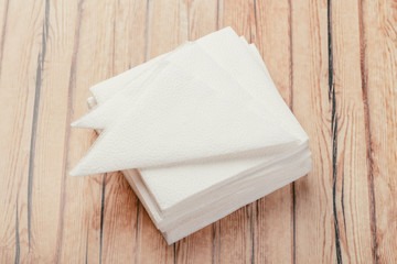 white paper napkin or tissue on the wooden table background.