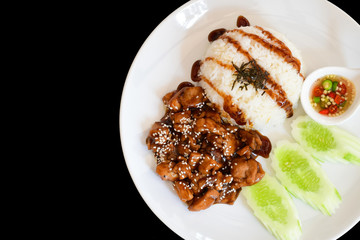 teriyaki chicken with rice, served with sesame seeds on jasmine rice, isolated on black background .top view