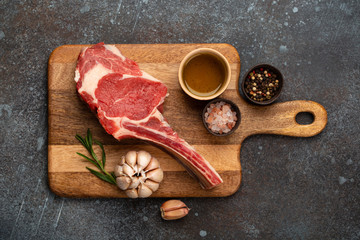 Raw marbled meat steak on wooden board