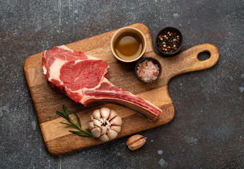 Raw marbled meat steak on wooden board