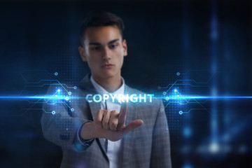 Business, Technology, Internet and network concept. Young businessman working on a virtual screen of the future and sees the inscription: Copyright