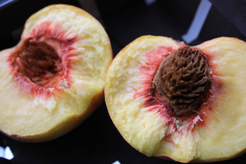 Two halves of a peach close up