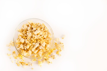 Top view of a bowl of popcorn on a white background. Flat top view. Copyspace for text.