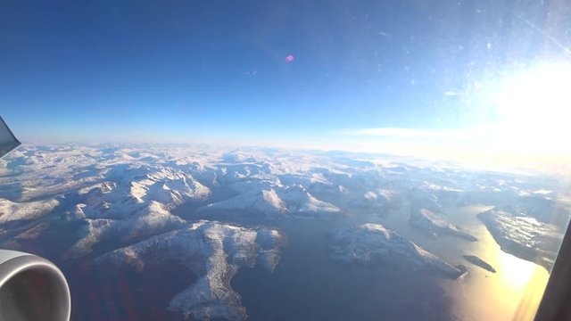 Aerial view over the snowy mountains of Northern Norway in the Arctic Circle during a beautiful winter day.
