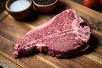 fresh T-Bone steak on wooden cutting board