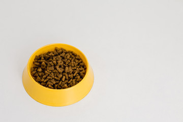 
cat food in a yellow bowl