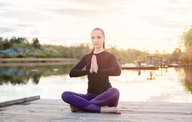 Fototapeta na wymiar Happy Young Woman do Yoga on Nature