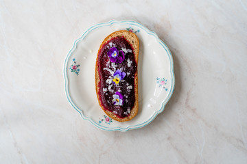 Vegetarian Bruschetta with Beet Paste Puree,  Toast Bread, Parmesan Cheese and Edible Flowers / Beetroot Hummus Dip.