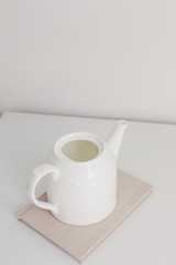 
white ceramic teapot on a white background