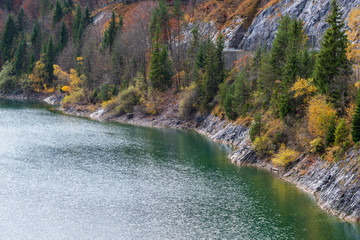 Alpine  Sylvenstein Stausee lake on Isar river, Bavaria, Germany. Autumn overcast, foggy and...
