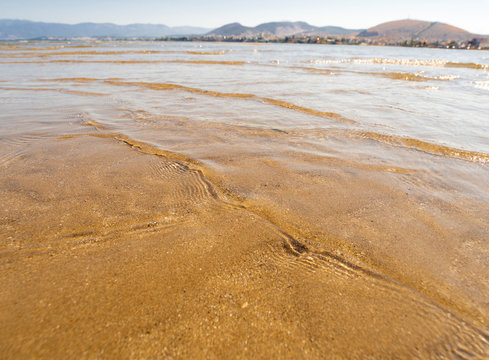 Panoramic views of the sandy beach,  mountains  the island of Evia on Liani Ammos beach in Halkida, Greece on a Sunny summer day
