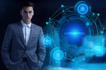 Business, Technology, Internet and network concept. Young businessman working on a virtual screen of the future and sees the inscription: Automation