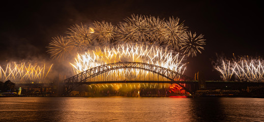 NYE fireworks on Sydney Harbour Bridge. Western view from Blues Point Reserve.