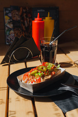 Street food on a wooden table on a sunny day