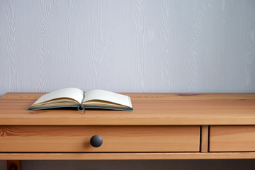 Notepad on a wooden table. Suitable for mockups and advertising backgrounds