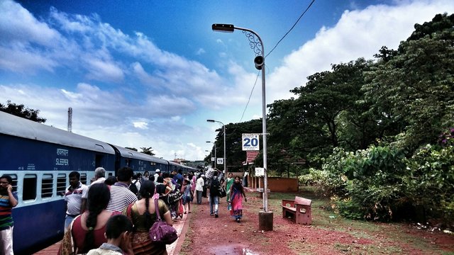 Passenger Train With Commuters On Thane Railway Station Platform Against Sky