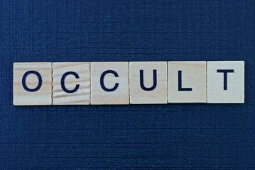  text on word occult from gray wooden letters on a black background