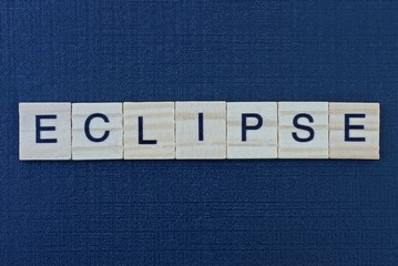  text on word eclipse from gray wooden letters on a black table