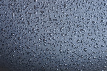 gray texture of many drops of water on a wet wall