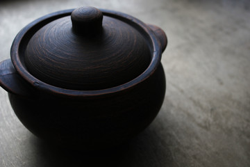 Clay pot on a dark background