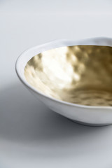 New luxury elegance cutlery view from above on a isolated background. Top view. Porcelain white soup bowl with golden ring. Trendy plate. Flat lay view.